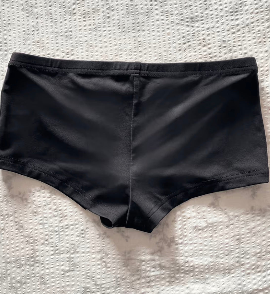 Back of black women's low-rise mini shorts