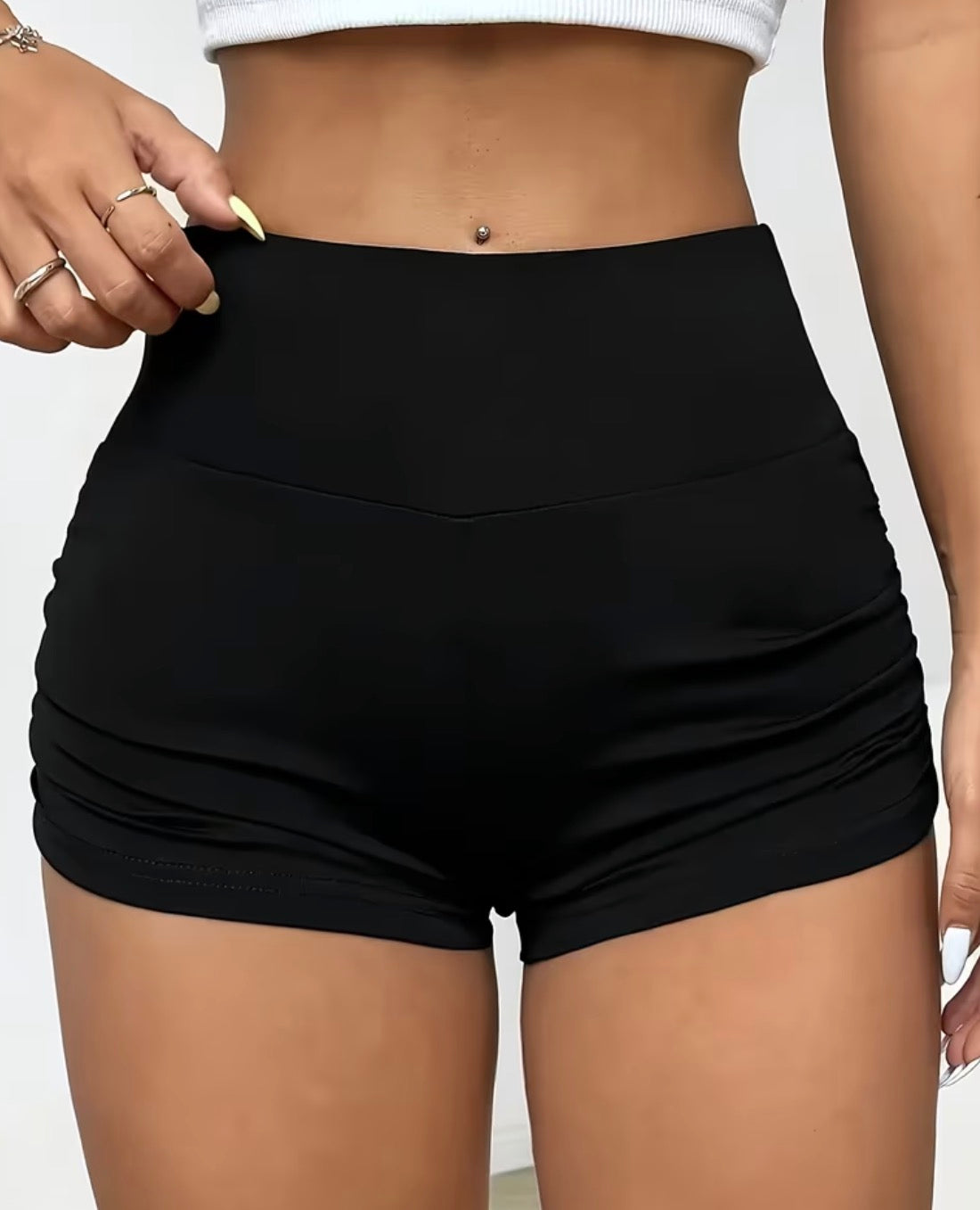 Front view of black high-waisted shorts with a wide waistband