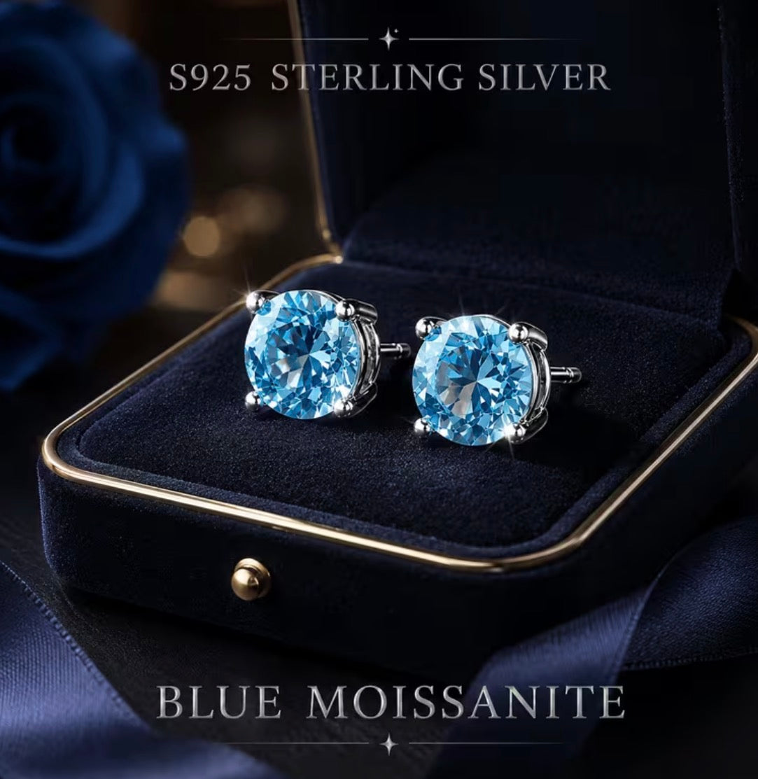 Pair of round blue moissanite stud earrings in sterling silver