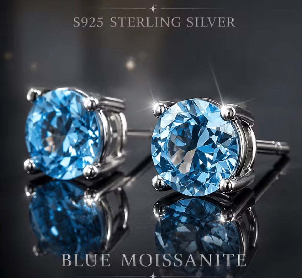 Close-up of blue moissanite earrings with four-prong settings